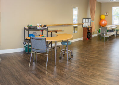 Treatment tables in open gym area cardio equipment and manual therapy desk