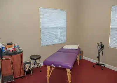 physical therapy private exam room with table and treatment supplies