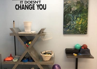 Physical Therapy clinic wall unit with therapy equipment and motivational quote on wall